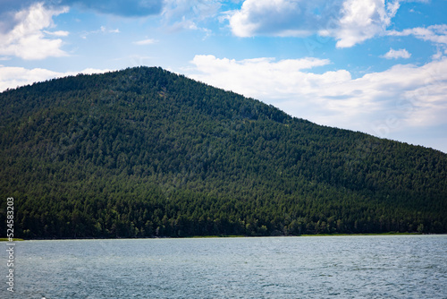 Lake and in the background is a mountain. Beach for relaxation in a mountainous area. © Igor Bastrakov