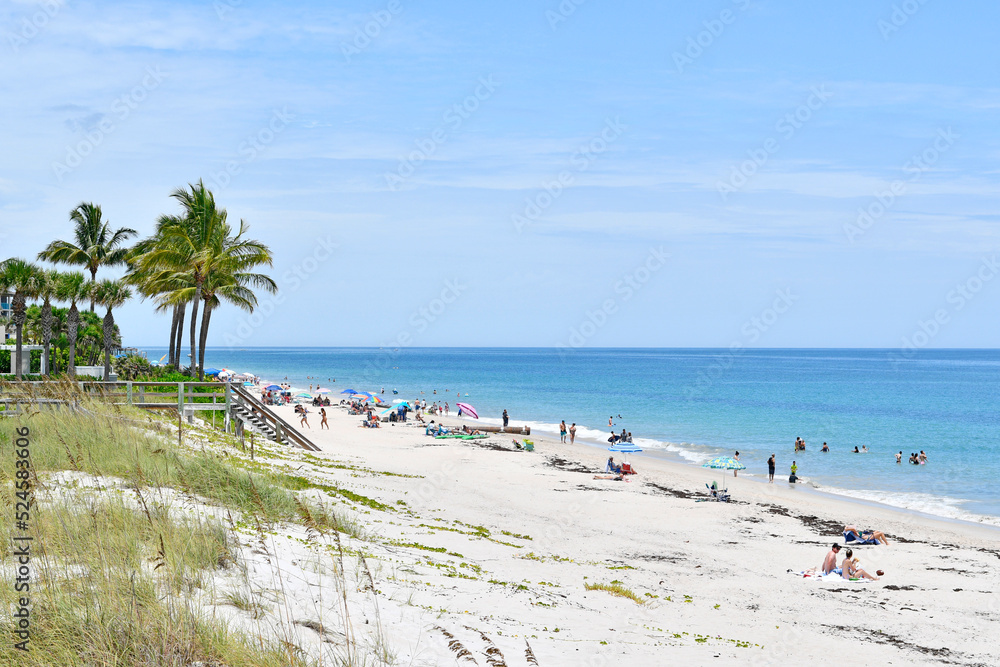Tourists and locals enjoying a sunny Vero Beach day in Florida on Hutchinson Island