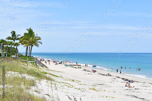 Fototapeta Naklejka Na Ścianę i Meble -  Tourists and locals enjoying a sunny Vero Beach day in Florida on Hutchinson Island