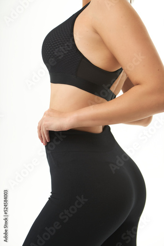 young slim woman posing in underwear and leggings. female back, buttocks. Concept beauty, body and skin care, medicine, health, spa, cosmetics,