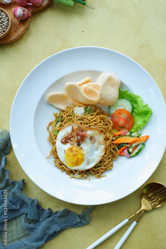 a plate of fried noodles served with vegetables a plate of fried noodles served with vegetables