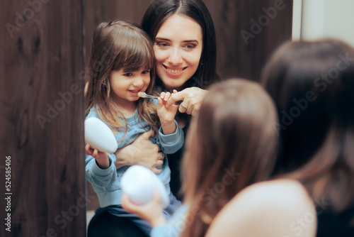 Mother Teaching her Child Proper Teeth Brushing Technique. Mom training her toddler daughter in dental care
