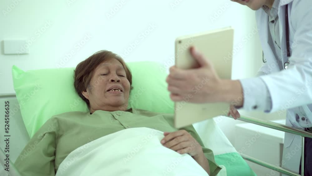 Doctor making a video call on tablet for female critical disease patient. Doctor making a video call on tablet for female critical disease patient.