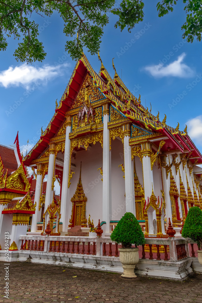 Naklejka premium Beautiful Wat Chalong Buddhist temples in Phuket Thailand. Decorated in beautiful ornate colours of red and Gold and Blue. Lovely Sky