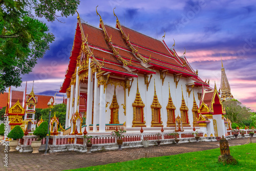 Beautiful Wat Chalong Buddhist temples in Phuket Thailand. Decorated in beautiful ornate colours of red and Gold and Blue. Lovely Sky photo