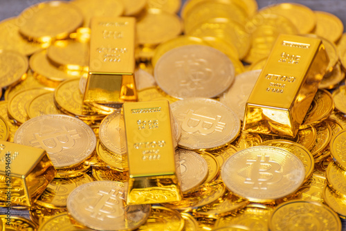 Bitcoin gold coins on a pile of gold coins, gold bars, virtual currency