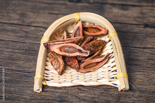 Dried betel nut products on wooden table and in bamboo basket