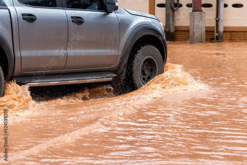 Flood. Puddles, cars drive through floods. and deep after Tropical Storm Mulan
