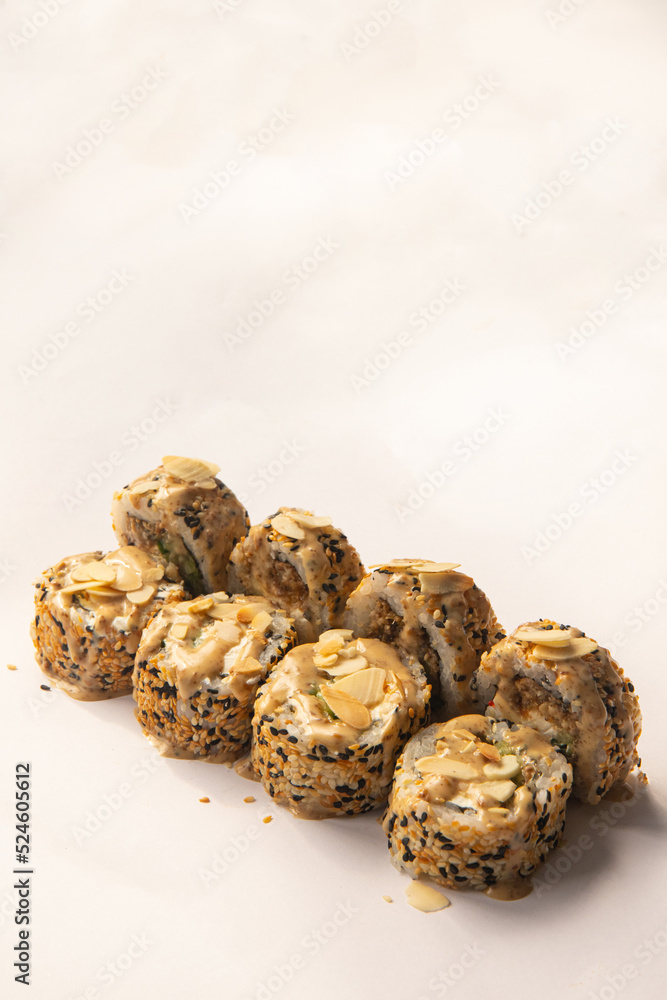 sushi rolls in sesame seeds with almond cream cheese and sauce sushi rolls in sesame seeds with almond cream cheese and sauce