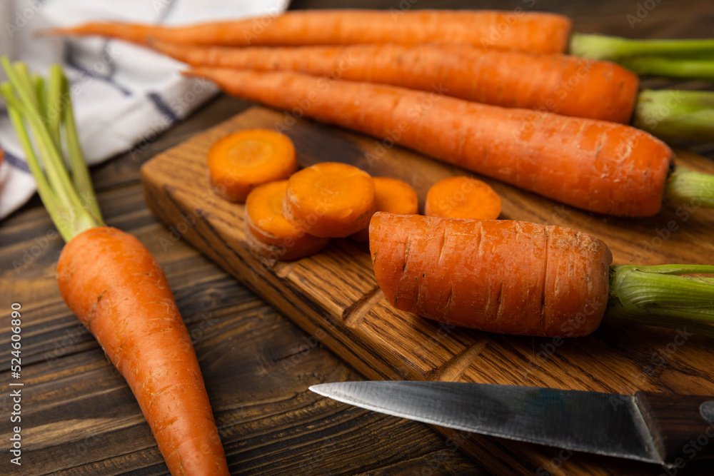Slice carrot.Fresh carrots on brown texture background. Ingredient for salad.Vegetarian organic vegetables.Healthy food.Copy space.Place for text Slice carrot.Fresh carrots on brown texture background. Ingredient for salad.Vegetarian organic vegetables.Healthy food.Copy space.Place for text