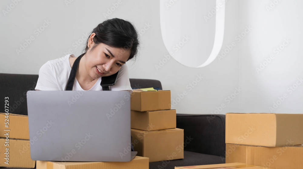 Startup small business SME, Entrepreneur owner using smartphone or tablet taking receive and checking online purchase shopping order to preparing pack product box. Selling online ideas concept Startup small business SME, Entrepreneur owner using smartphone or tablet taking receive and checking online purchase shopping order to preparing pack product box. Selling online ideas concept