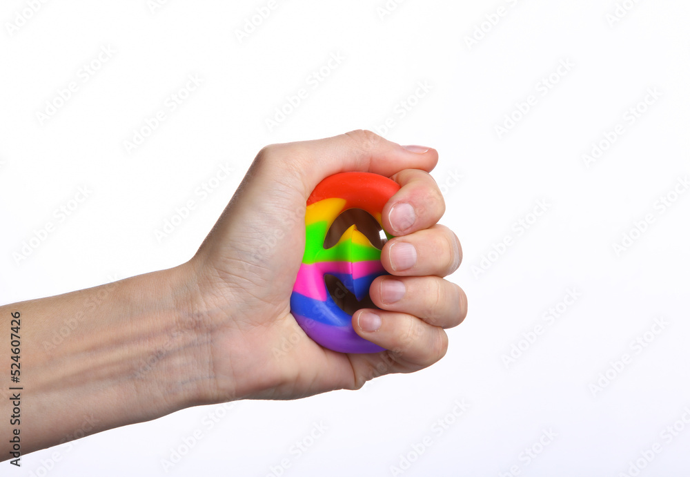 Female hand squeezing antistress snapperz toy on white background Female hand squeezing antistress snapperz toy on white background