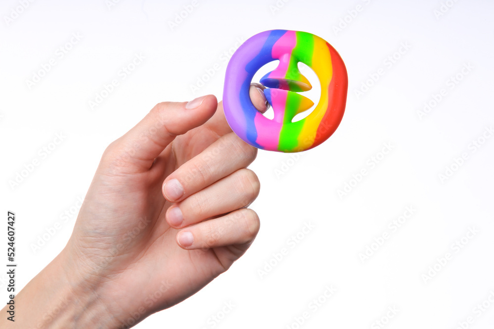 Female hand squeezing antistress snapperz toy on white background Female hand squeezing antistress snapperz toy on white background