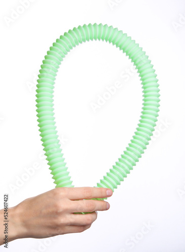 Female hand holding a pop tube on white background photo