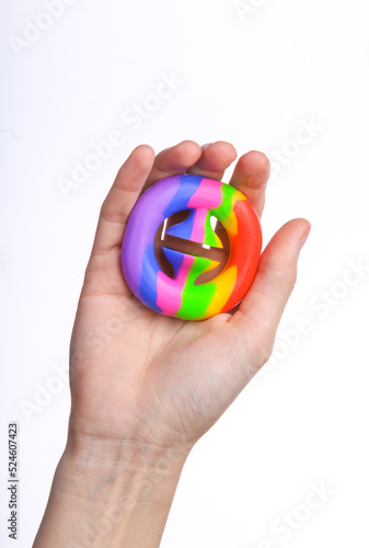 Wallpaper Mural Female hand squeezing antistress snapperz toy on white background Torontodigital.ca