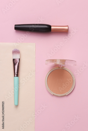 Minimal beauty composition. Makeup brush, powder box and mascara. Top view