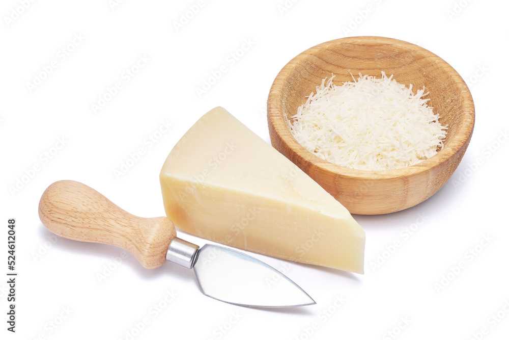 Piece of parmesan cheese, knife and grated cheese in wooden bowl isolated on white background