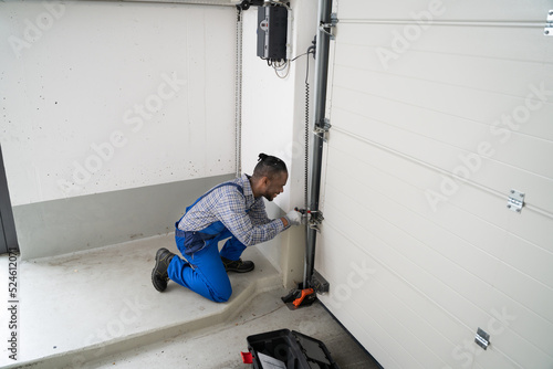 Garage Door Installation And Repair At Home. Contractor Man
