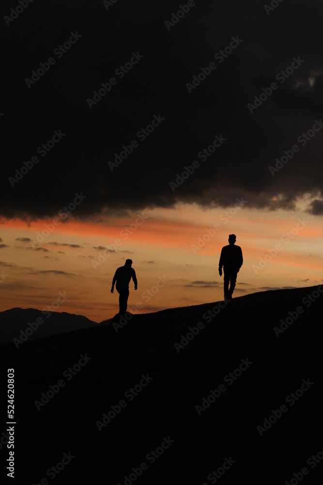 gay couples in mountain top at sunset