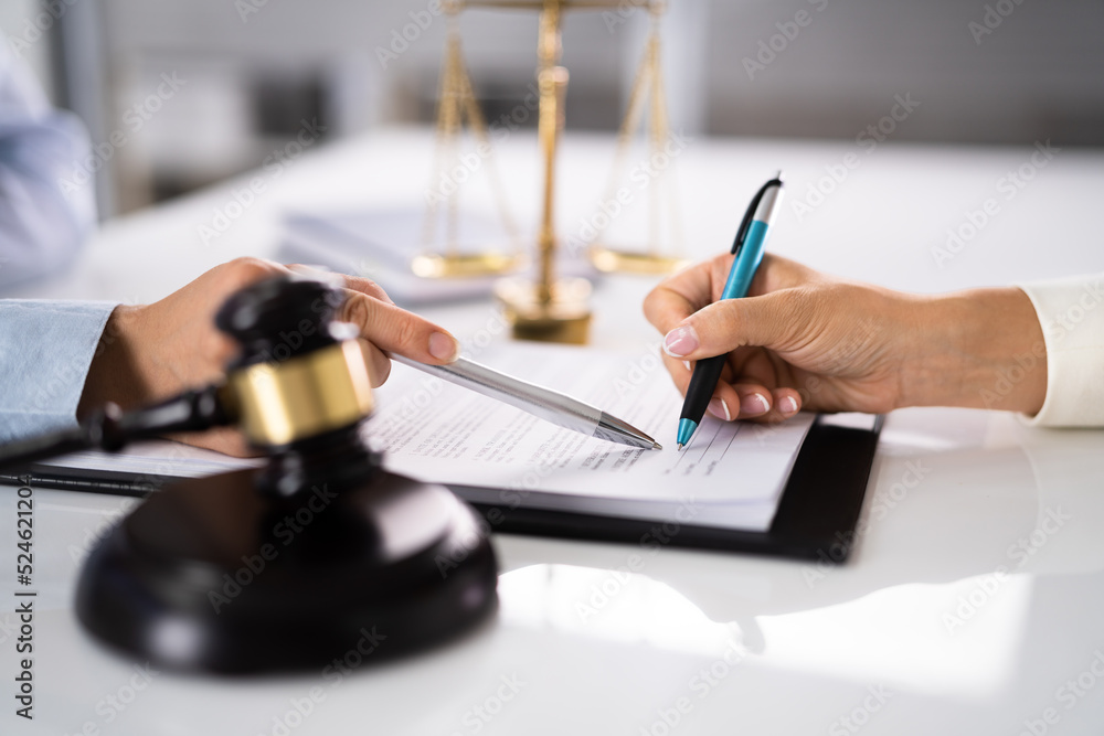 Judge Assisting Client To Sign Legal Document Judge Assisting Client To Sign Legal Document