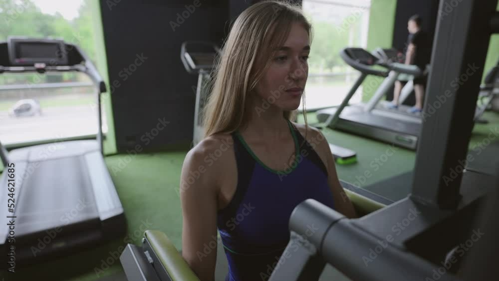 young fit and muscular female training in atmospheric dark gym. Health and wellness concept young fit and muscular female training in atmospheric dark gym. Health and wellness concept