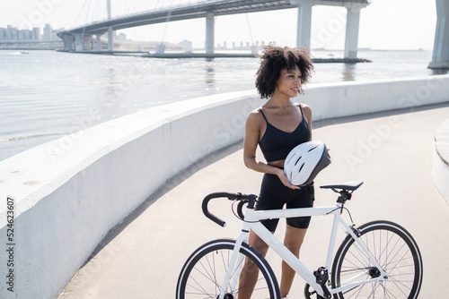 Cyclist young woman riding a bike training in a cycling suit in the city