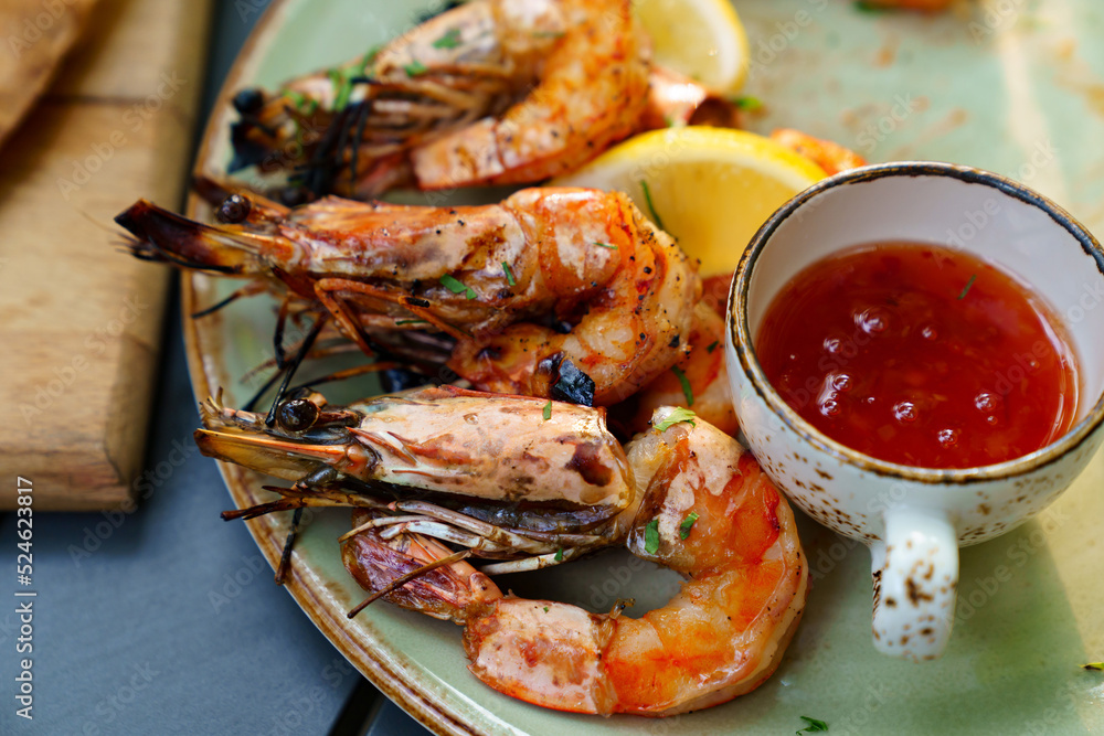 seafood. shrimp cooked on the grill with sauce and vegetables. seafood. shrimp cooked on the grill with sauce and vegetables.