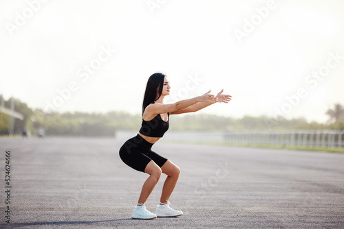 Fitness runner body close up, woman doing warm-up before jogging, stretching leg muscles, Female athlete prepares legs for cardio workout, outdoor exercise in city