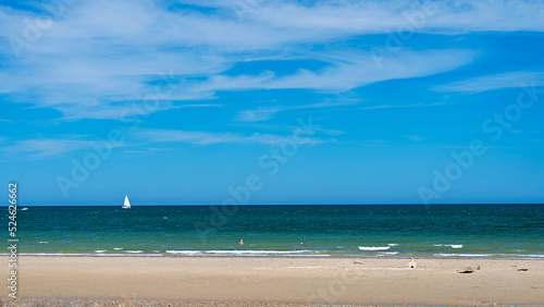 Fototapeta Naklejka Na Ścianę i Meble -  Panoramic view of beach with sailing yacht in ocean sailing and sky in background