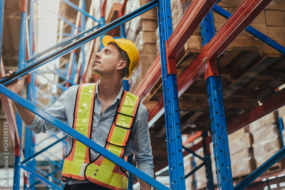 Warehouse Workers checking stock with digital Tablet in Logistic center. Caucasian manager wearing safety vests to working about shipment in storehouse, Working in Storage Distribution Center.