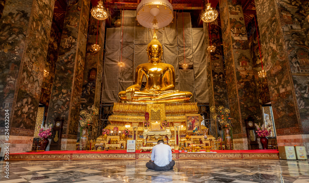 Giant Buddha sculpture at landmark Buddhist temple at Wat Suthat in Bangkok