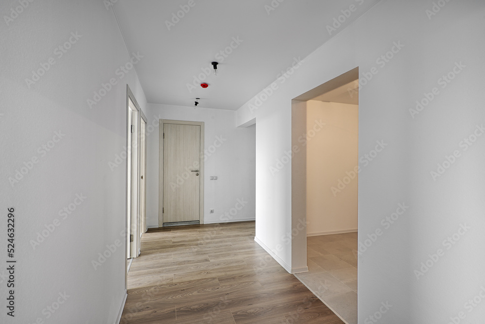Empty room after repairs in an apartment building. Standard, stereotype fresh renovated room with wooden floor Empty room after repairs in an apartment building. Standard, stereotype fresh renovated room with wooden floor