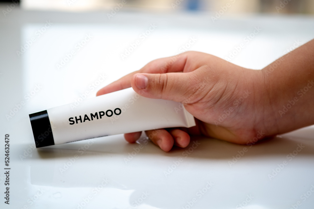 Obraz premium tube containing liquid shampoo with a stone texture and soap foam background