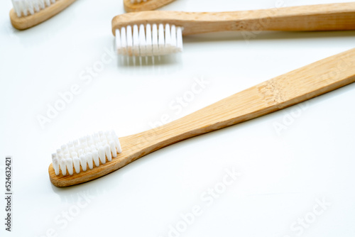 Eco-friendly toothbrush with wooden bamboo handle.