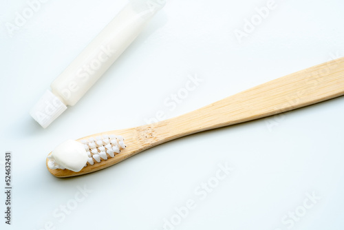 Eco-friendly toothbrush with wooden bamboo handle.