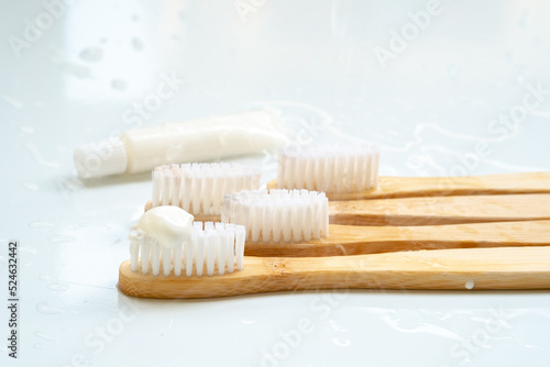 Eco-friendly toothbrush with wooden bamboo handle.