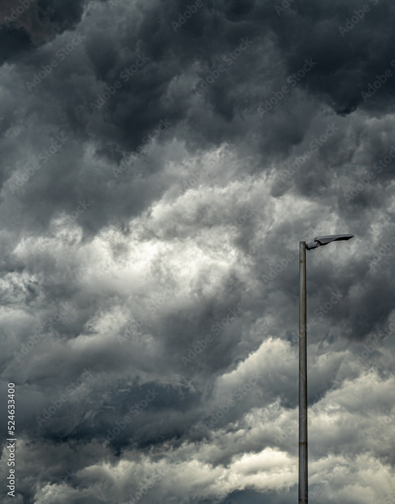 Lamppost before an immensity of clouds before a storm