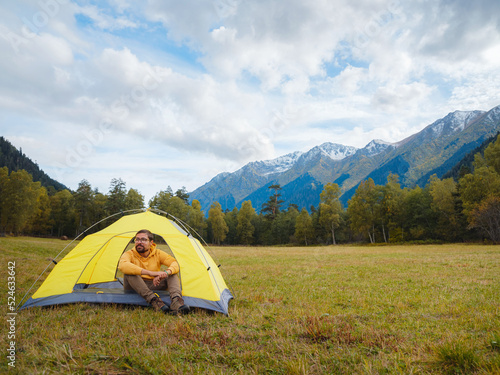 trip to Caucasus mountains, Arkhyz, Teberdinsky reserve. Man traveler relaxing in mountains in tent camping outdoor Travel adventure lifestyle concept hiking active vacations.