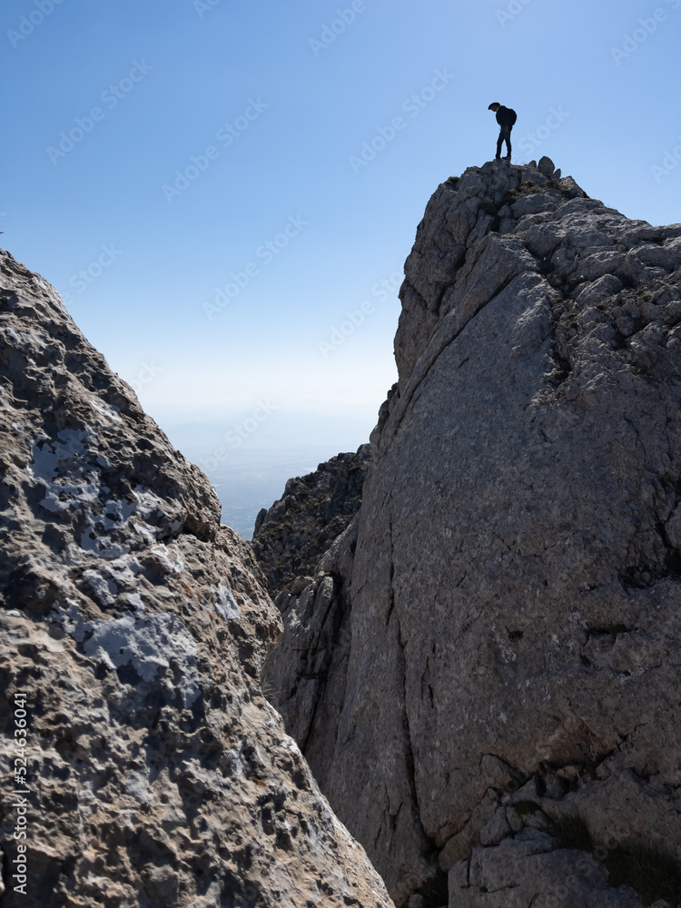 adventurous man's trek in majestic mountains in risky places