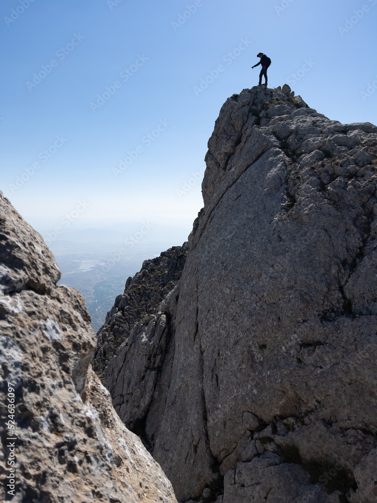 adventurous man's trek in majestic mountains in risky places