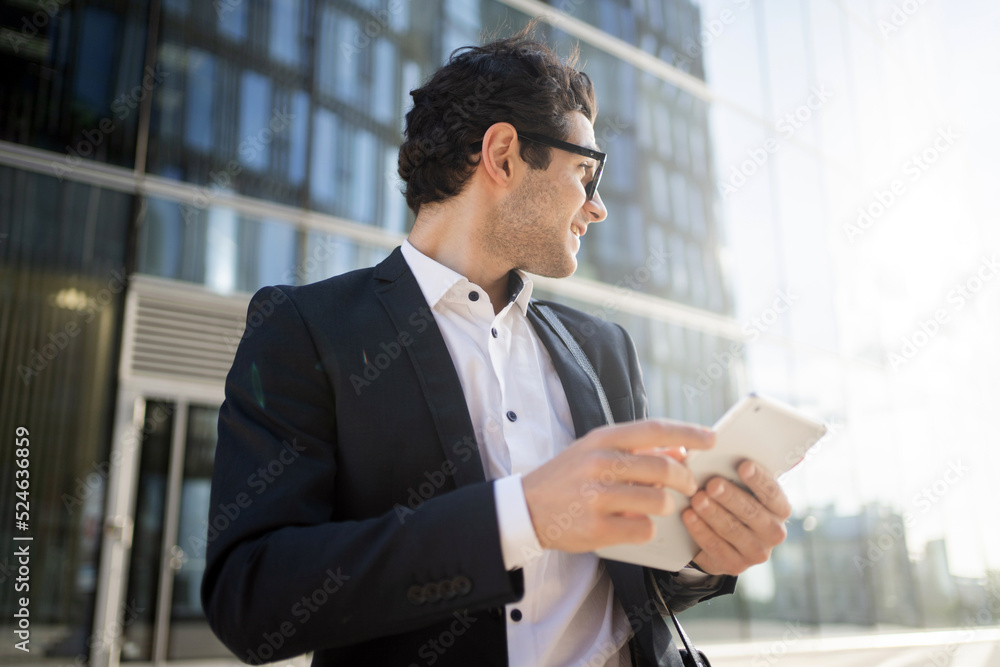 A male manager is using a tablet, an employee in a financial company is building a career A male manager is using a tablet, an employee in a financial company is building a career
