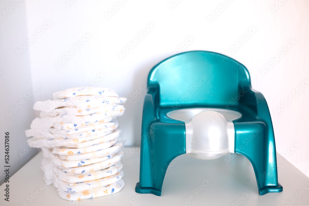 Baby potty and diapers. The concept of potty training, child education
