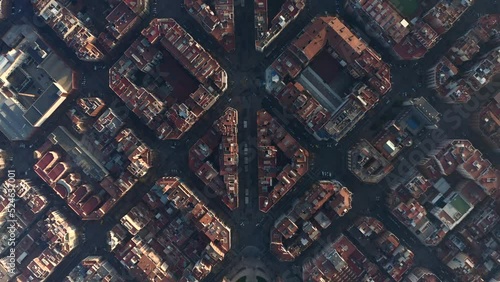 Streets and buildings lit by low sun. Overhead view of development in Eixample district. Barcelona, Spain photo