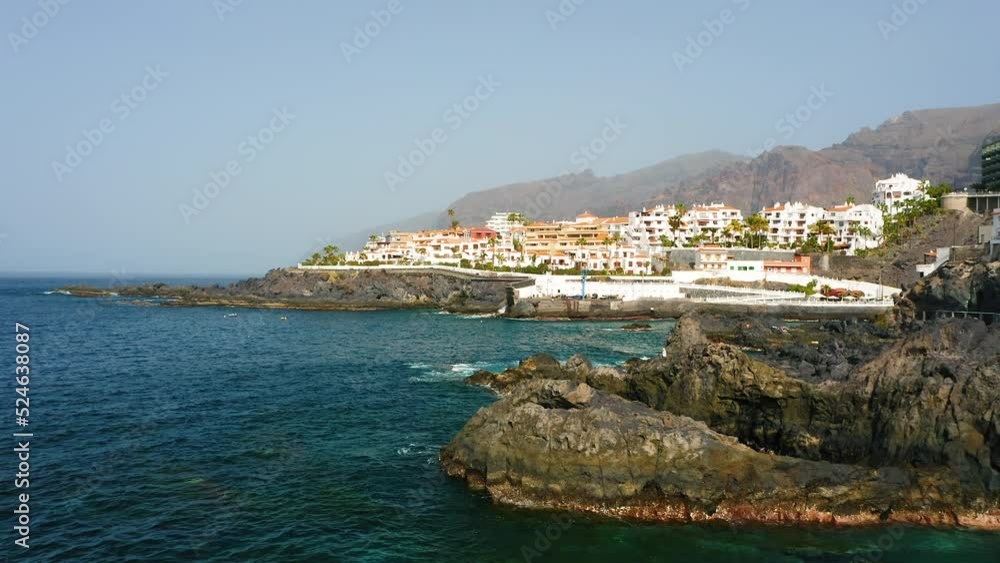 Tenerife, Canary Island, town Puerto de Santiago, playa. Aerial view of black rocky beach and natural pool in Atlantic Ocean. Bay. Azure turquoise water. Piscina natural. Tenerife, Canary Island, town Puerto de Santiago, playa. Aerial view of black rocky beach and natural pool in Atlantic Ocean. Bay. Azure turquoise water. Piscina natural.