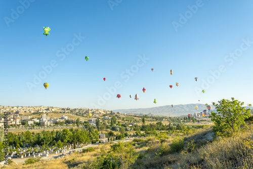 Göreme village, Nevsehir, Nevsehir Merkez, Cappadocia, Turkey - 07.28.2022: Hot air balloon launch over Cappadocia, hot air balloon parade
