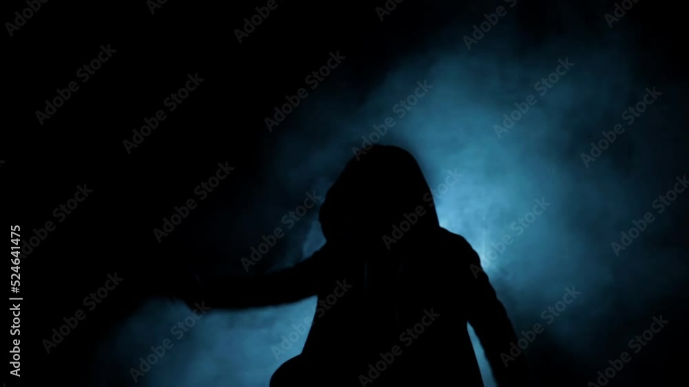Female Hitman with a gun in dramatic light, and smoke Cinematic shot. Female Hitman with a gun in dramatic light, and smoke Cinematic shot.