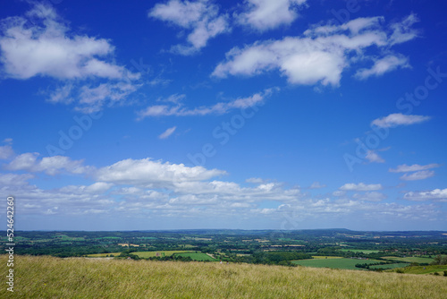 Views over green fields and blue sky with clouds