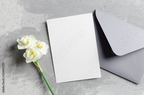 Invitation or greeting card mockup with envelope and daffodils flowers