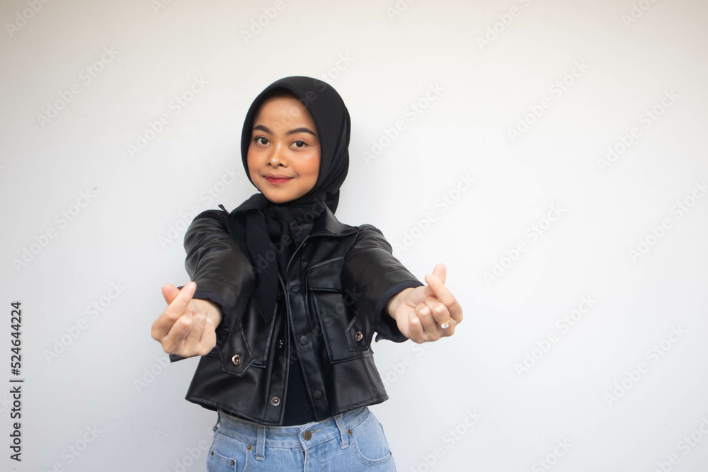 Asian beautiful smiling hijab girl showing love korea sign with finger with blurred background isolated white background. Indonesian Women Asian beautiful smiling hijab girl showing love korea sign with finger with blurred background isolated white background. Indonesian Women