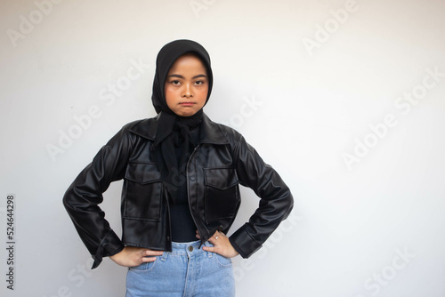 Beautiful young Asian Muslim woman keep hands on waist to show feeling annoyed isolated over white background